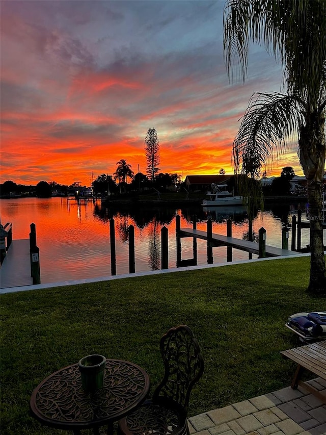 view of dock featuring a yard and a water view