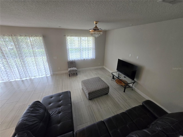 living room with baseboards and a textured ceiling