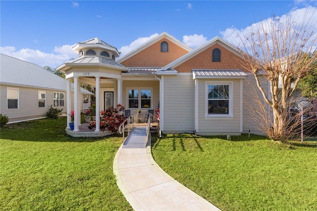 view of front of house with a front lawn and a gazebo