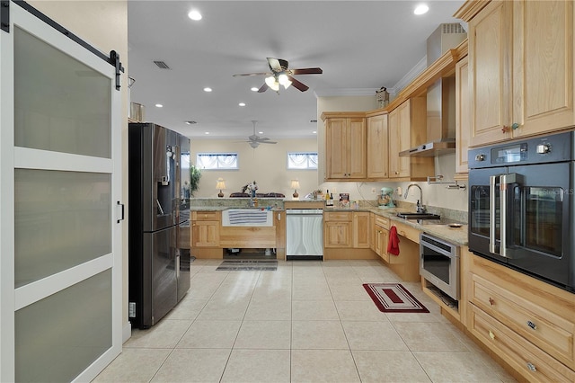 kitchen featuring wall chimney range hood, light brown cabinetry, ceiling fan, and black appliances