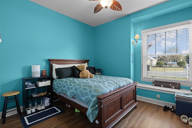 bedroom featuring dark hardwood / wood-style flooring and ceiling fan