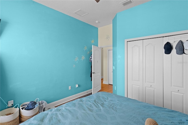 bedroom featuring a closet and light hardwood / wood-style flooring