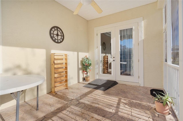 view of exterior entry with french doors, a patio area, and ceiling fan