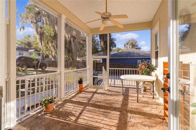 sunroom / solarium with ceiling fan