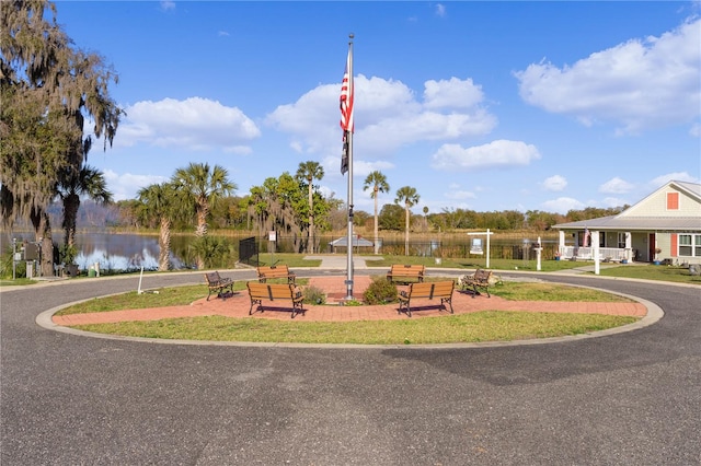 exterior space with a water view and a lawn