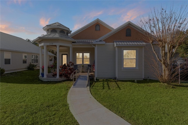 view of front of house with a gazebo and a lawn