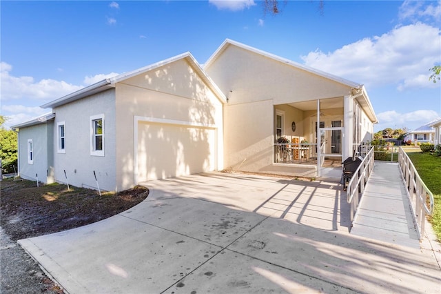 rear view of property with a garage