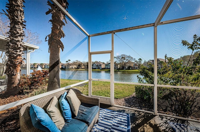 unfurnished sunroom featuring a water view