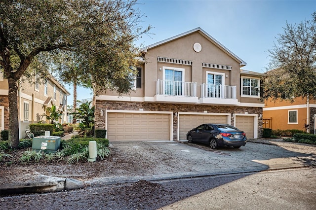 view of front of house with a garage and a balcony