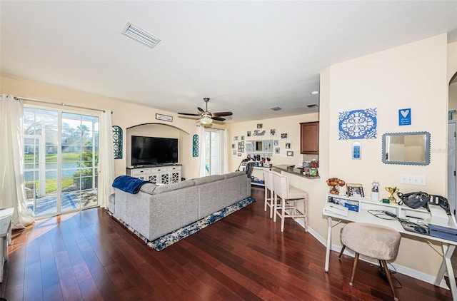 living room with dark hardwood / wood-style floors and ceiling fan