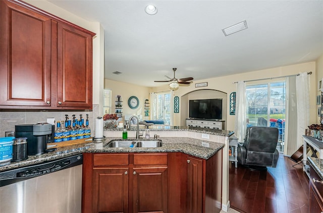 kitchen featuring sink, stainless steel dishwasher, dark hardwood / wood-style flooring, and kitchen peninsula