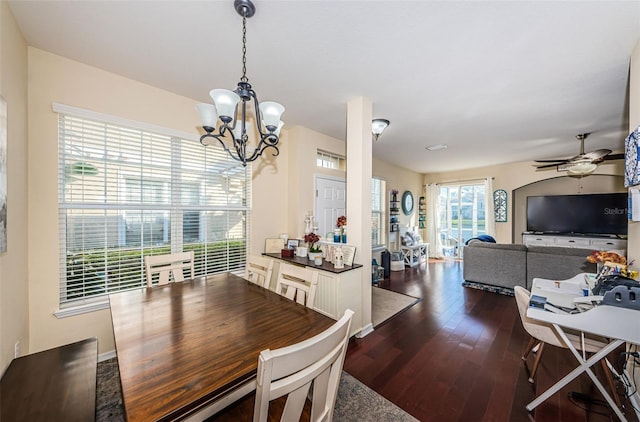 dining room featuring dark hardwood / wood-style flooring and ceiling fan with notable chandelier