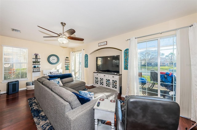 living room with dark hardwood / wood-style flooring and ceiling fan