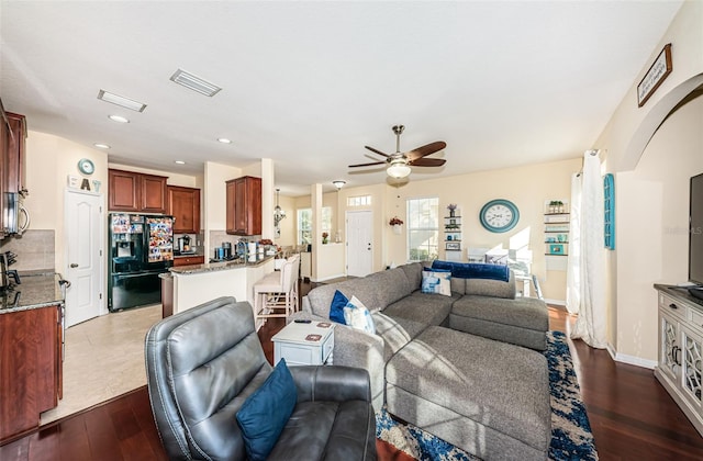 living room with ceiling fan and hardwood / wood-style floors