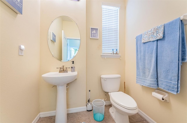 bathroom with tile patterned floors and toilet