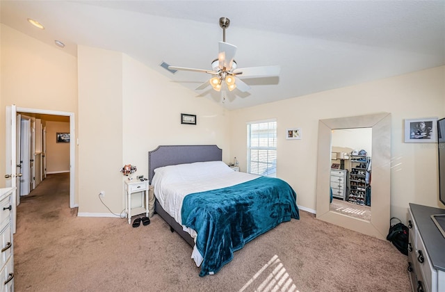 carpeted bedroom with vaulted ceiling and ceiling fan