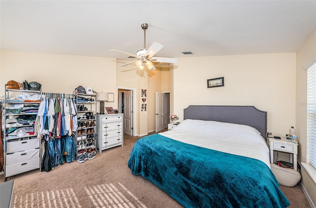 carpeted bedroom with vaulted ceiling and ceiling fan