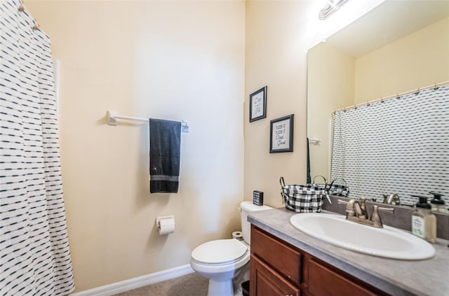 bathroom with walk in shower, vanity, and toilet