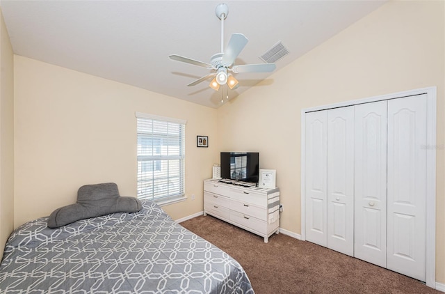 bedroom featuring vaulted ceiling, carpet flooring, ceiling fan, and a closet