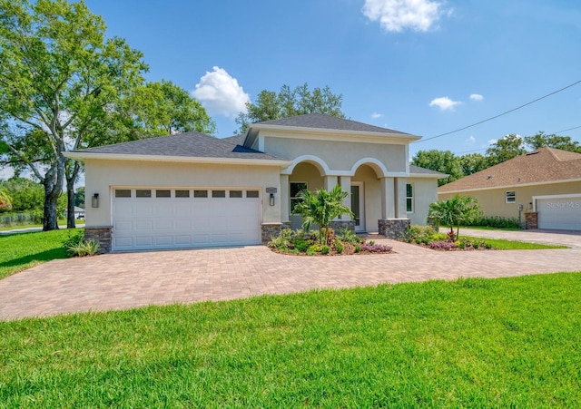 view of front of home with a front yard and a garage