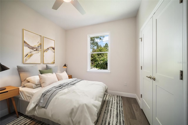 bedroom featuring dark hardwood / wood-style floors, a closet, and ceiling fan