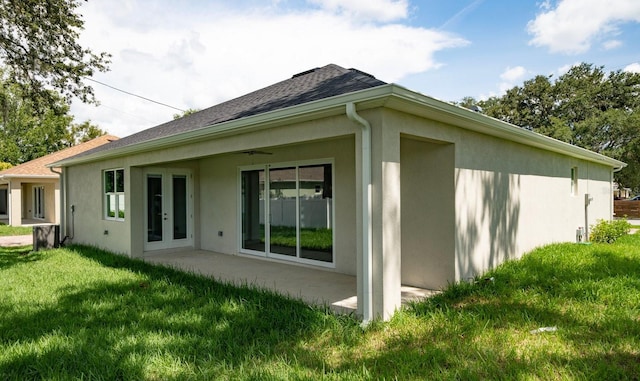 view of side of home featuring a patio and a yard