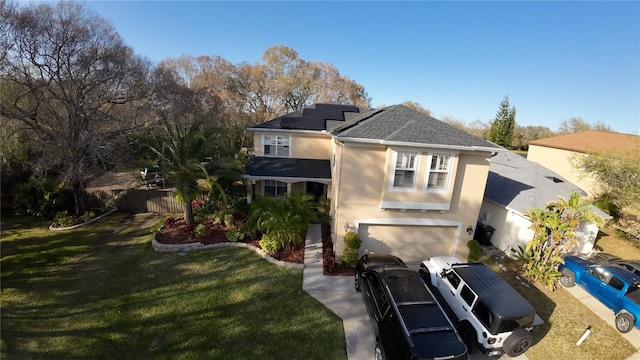 back of property featuring a yard and a garage