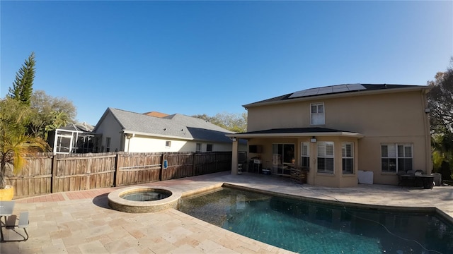 exterior space featuring solar panels, a pool with hot tub, and a patio