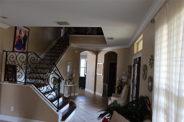 tiled entrance foyer featuring ornamental molding