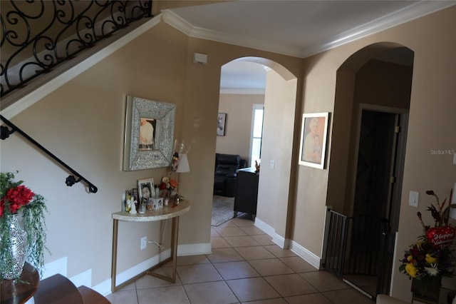 hall with crown molding and light tile floors