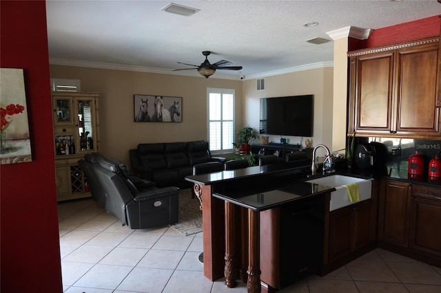 kitchen featuring kitchen peninsula, ceiling fan, light tile floors, sink, and crown molding