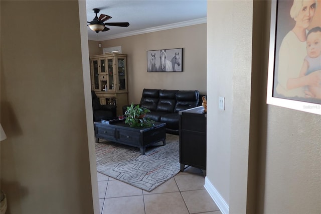 tiled living room featuring crown molding and ceiling fan