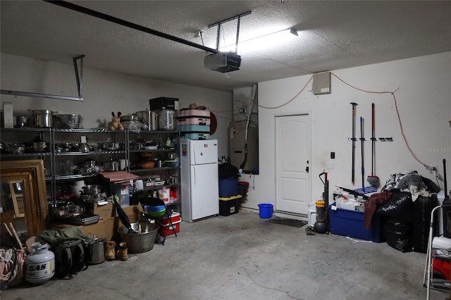 garage with a garage door opener, heating utilities, and white refrigerator