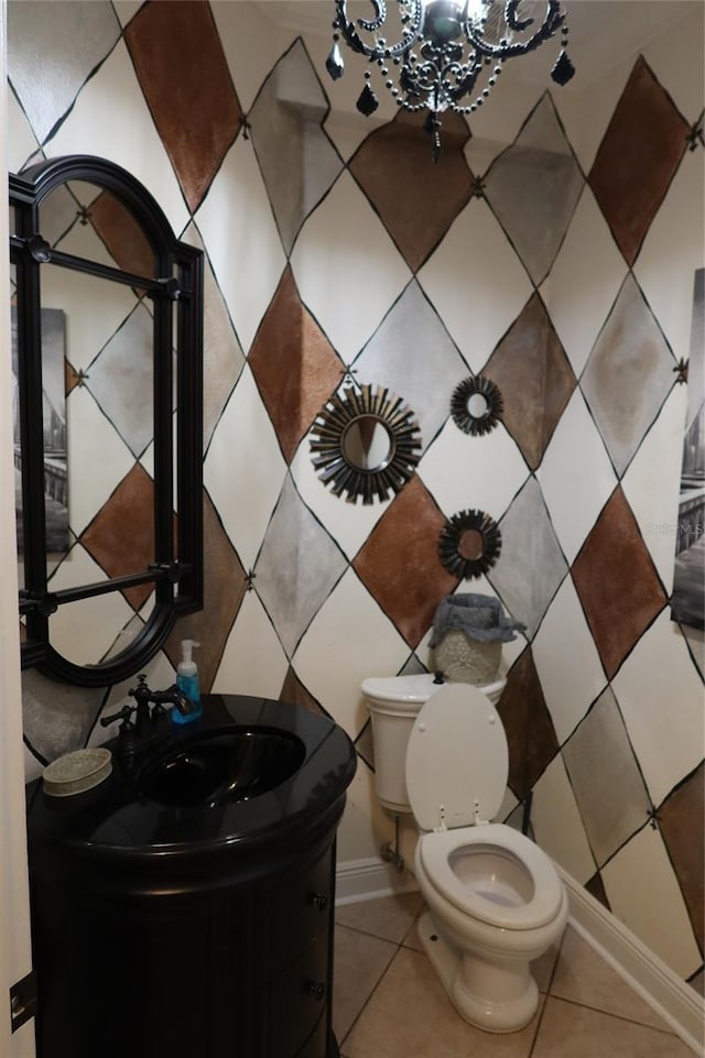 bathroom with a notable chandelier, tile floors, large vanity, and toilet