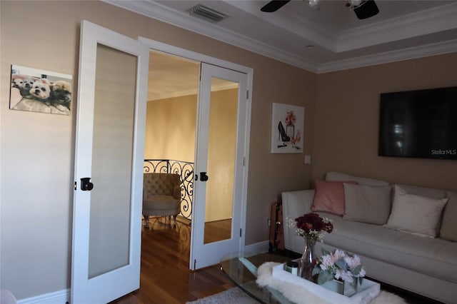 living room with ceiling fan, dark hardwood / wood-style floors, french doors, and a raised ceiling