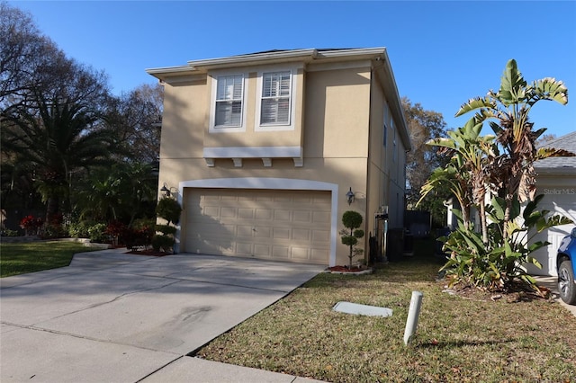 view of property with a front lawn and a garage