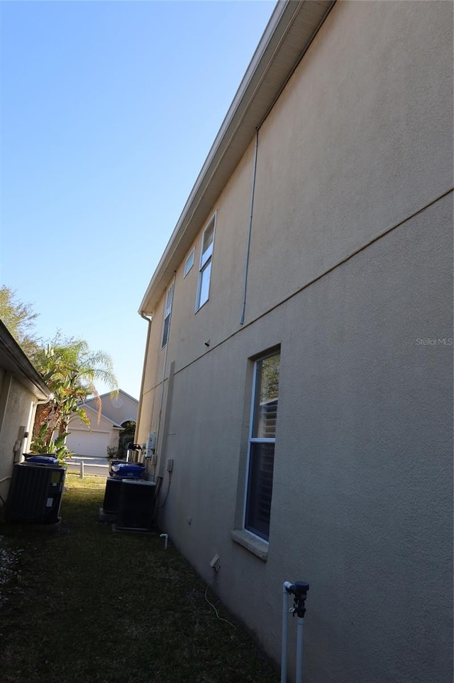 view of side of property with central air condition unit