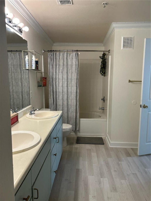 full bathroom with vanity, toilet, ornamental molding, wood-type flooring, and shower / tub combo