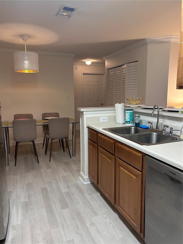 kitchen with dishwasher, sink, hanging light fixtures, light wood-type flooring, and ornamental molding