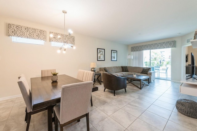 dining area featuring a chandelier and light tile floors