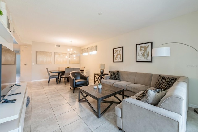 living room featuring light tile floors and an inviting chandelier