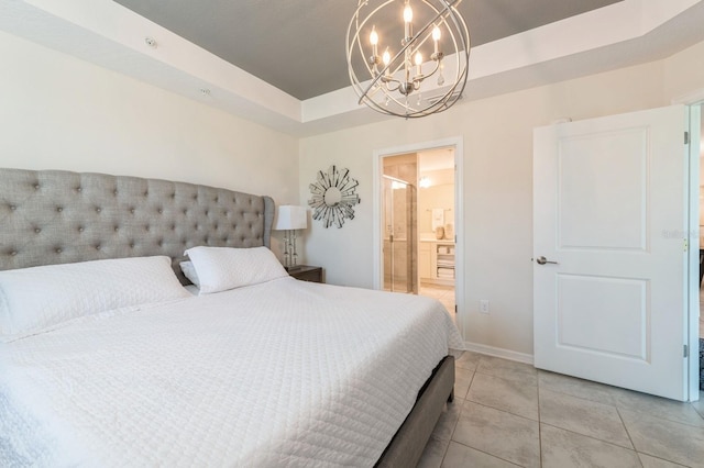 bedroom featuring a raised ceiling, ensuite bath, an inviting chandelier, and light tile flooring