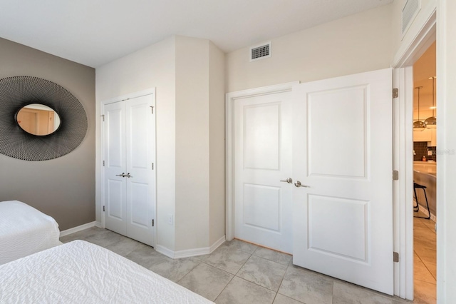 bedroom featuring light tile floors