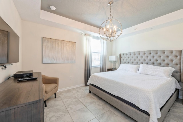 tiled bedroom featuring a chandelier and a raised ceiling