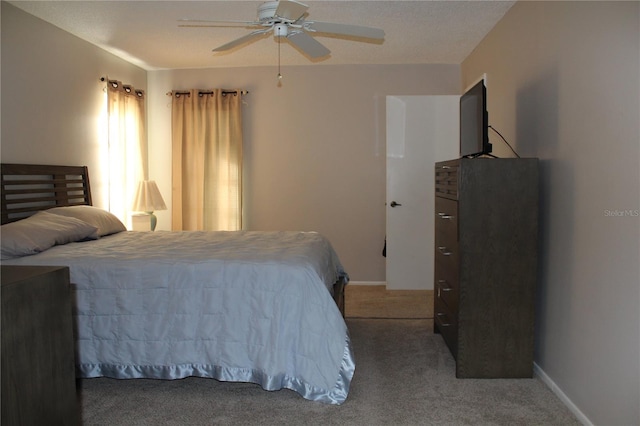 bedroom with ceiling fan and carpet floors