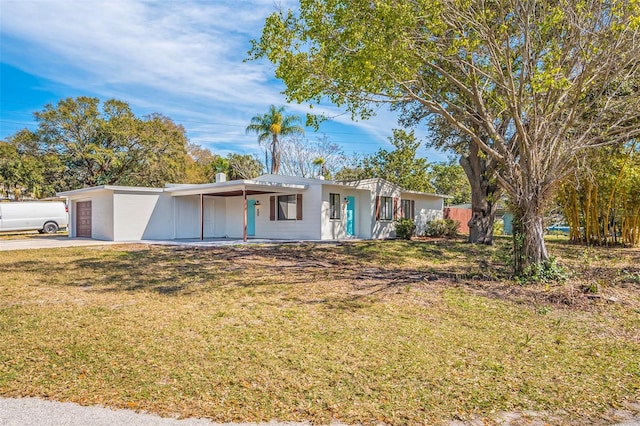 ranch-style home with covered porch and a front lawn