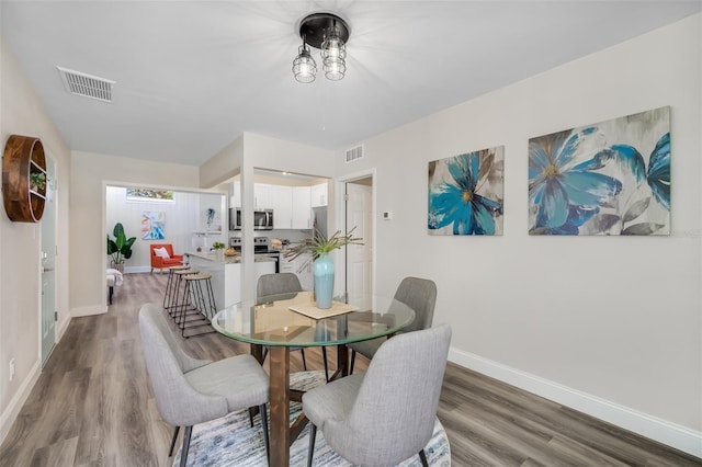 dining area with wood-type flooring