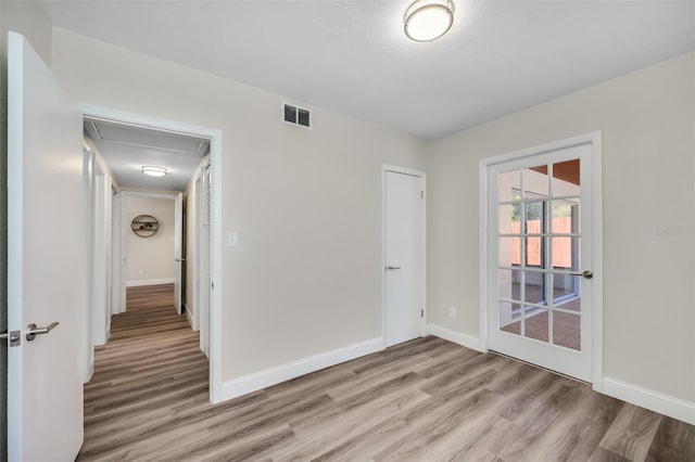 empty room with light hardwood / wood-style flooring