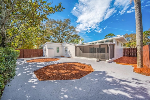 view of front of property with a patio and a sunroom