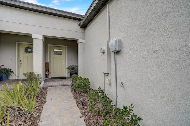 doorway to property with stucco siding